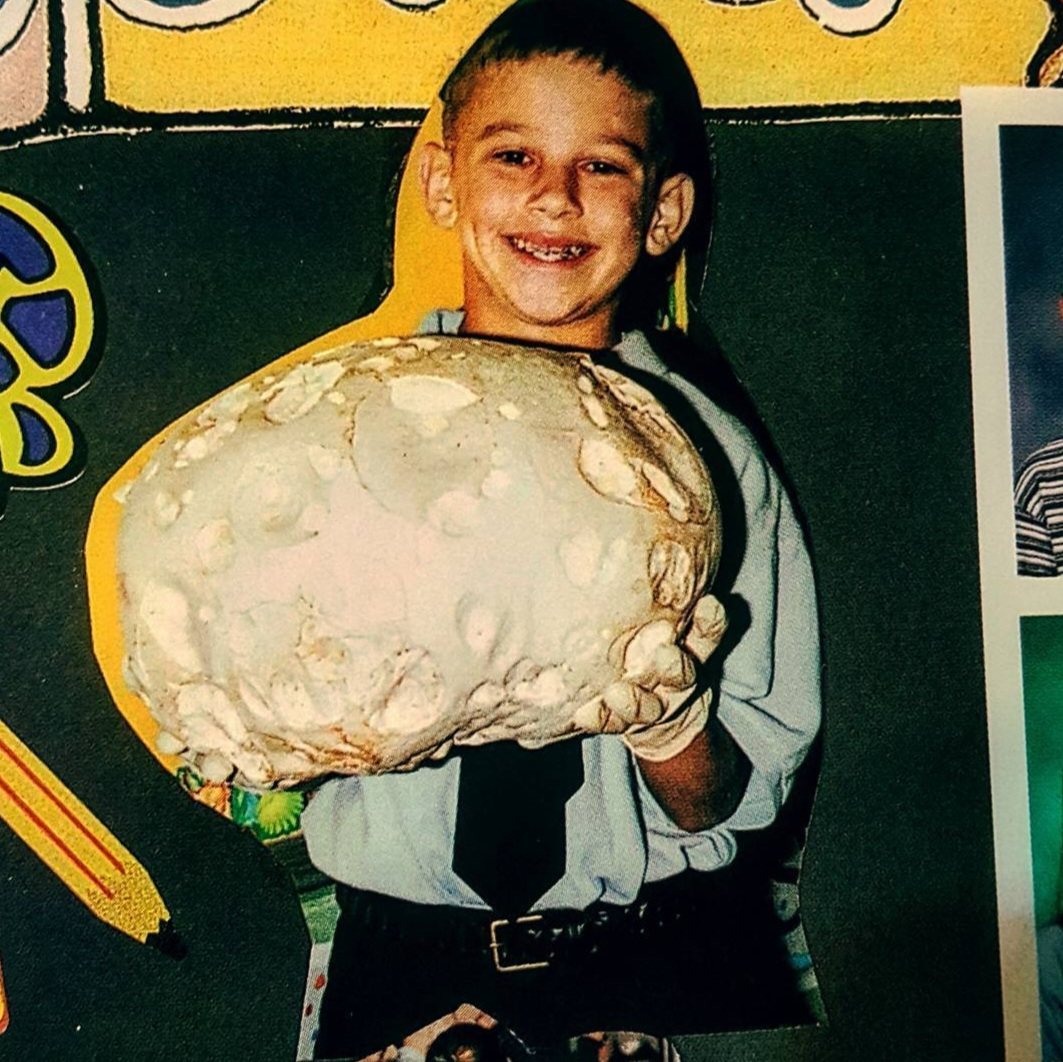 Matthew as a child holding a giant puffball